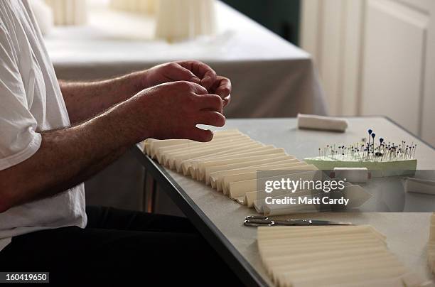 Frohmut Zscheckel helps put the finishing touches to artist Joan Sallas' new exhibition 'Folded Beauty: Masterpieces in Linen', which is opening at...