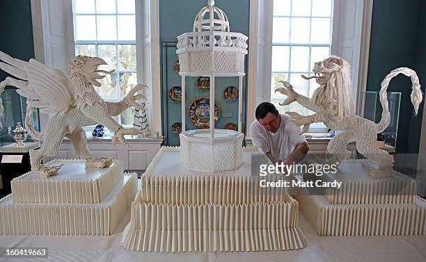Frohmut Zscheckel helps put the finishing touches to artist Joan Sallas' 1.5-metre-high folded linen table fountain he is displaying as part of a new...