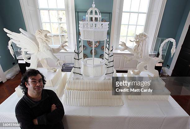 Artist Joan Sallas stands beside a 1.5 metre high folded linen table fountain he is displaying as part of a new exhibition 'Folded Beauty:...