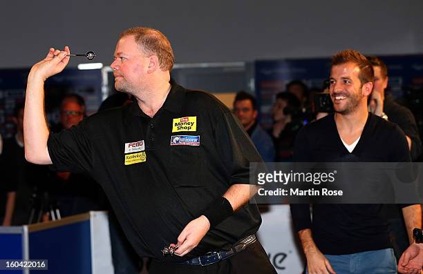 Raymond van Barneveld of Netherlands in action during a dart show tournament at between team Netherlands and Hamburger SV at Imtech Arena on January...