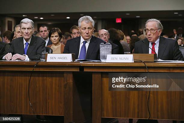 Former U.S. Sen. Chuck Hagel listens to former U.S. Sen. John Warner and former U.S. Sen. Sam Nunn , both former chairmen of the Senate Armed...