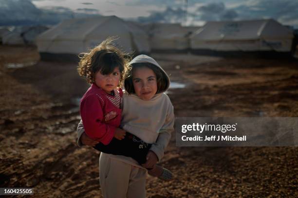 Syrian refugee children play in the Za’atari refugee camp on January 31, 2013 in Za'atari, Jordan. Record numbers of refugees are fleeing the...