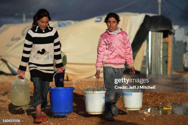 Syrian fetch water in the Za’atari refugee camp on January 31, 2013 in Za'atari, Jordan. Record numbers of refugees are fleeing the violence and...