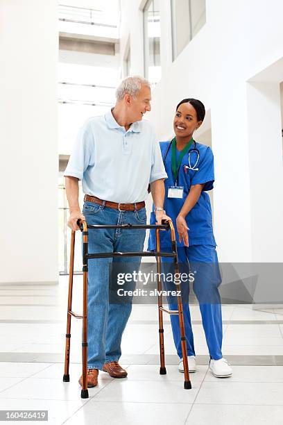 nurse helping a patient with walker - hhp5 stock pictures, royalty-free photos & images