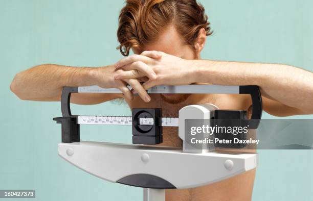 distraught man with eating disorder - anorexia nervosa stock pictures, royalty-free photos & images