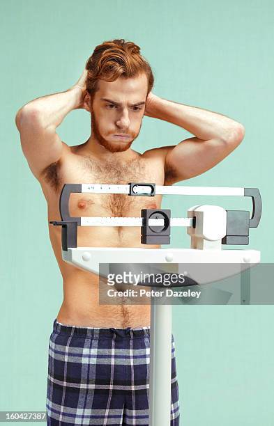 man with eating disorder depressed - weight gain foto e immagini stock