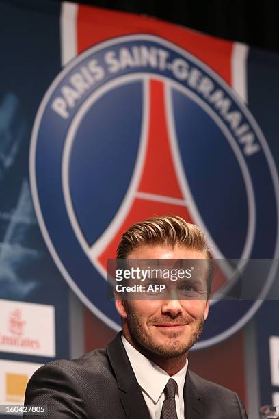 Former England captain David Beckham smiles as he takes part in a press conference after signing for Paris Saint Germain at Parc des Princes in Paris...