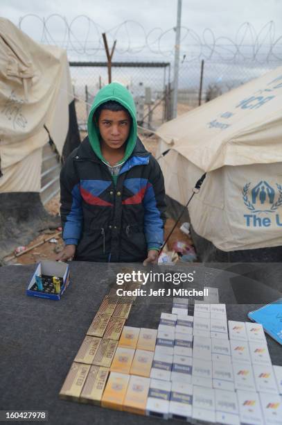 Young Syrian sells cigarettes in the Za’atari refugee camp on January 31, 2013 in Za'atari, Jordan. Record numbers of refugees are fleeing the...