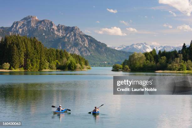 canoists on illasbergsee, bavaria, germany - bavaria stock pictures, royalty-free photos & images