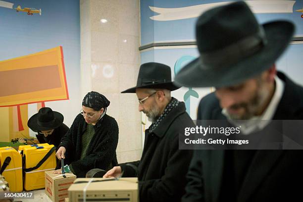 Israelis collect gas mask kits from a distribution station in a mall January 31 in Pisgat Ze'ev, East Jerusalem, Israel. Israel remains on high alert...