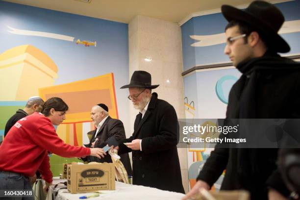 Israelis collect gas mask kits from a distribution station in a mall January 31 in Pisgat Ze'ev, East Jerusalem, Israel. Israel remains on high alert...