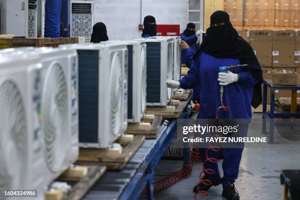 Saudi women assemble air conditioning units at a factory in Dammam, in Saudi Arabia's eastern province on August 15, 2023.