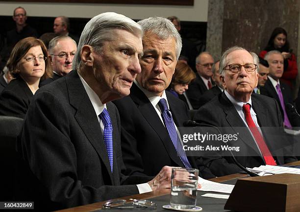 Former U.S. Sen. John Warner speaks as Sen. Chuck Hagel and former Sen. Sam Nunn look on during Hagel's confirmation hearing to become the next...