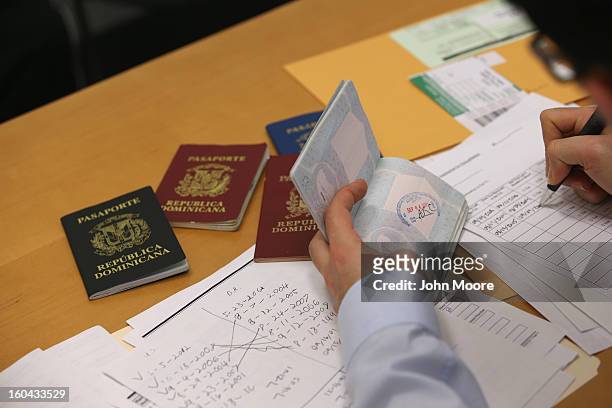 An immigration lawyer sorts through an immigrant's valid and expired passports from the Dominican Republic on January 31, 2013 in New York City....