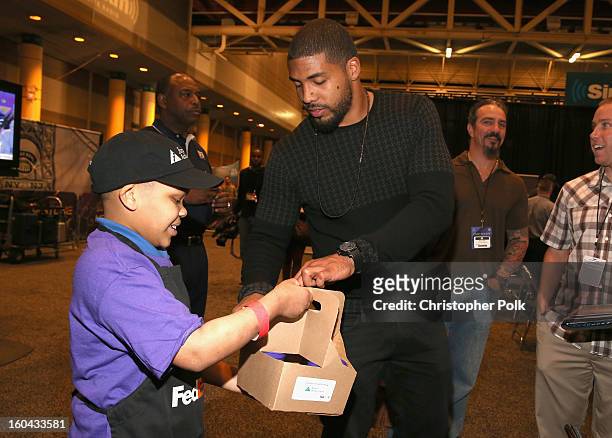 Running back Arian Foster of the Houston Texans attends the FedEx lemonade stand with Junior Achievement students in the Super Bowl XLVII Media...
