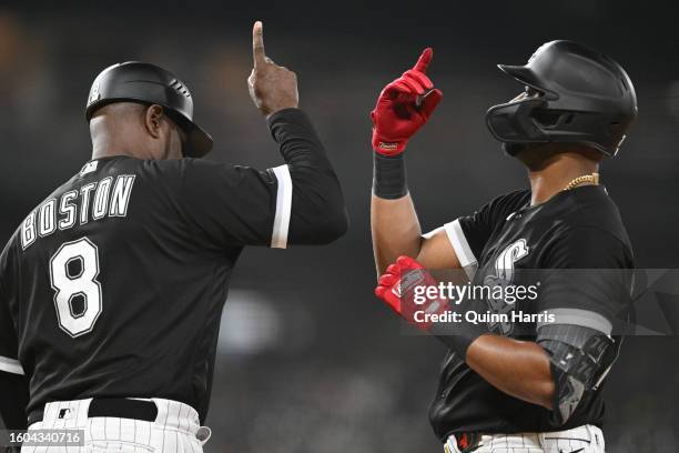 Eloy Jimenez of the Chicago White Sox celebrates with third base coach Daryl Boston of the Chicago White Sox in the fifth inning against the New York...