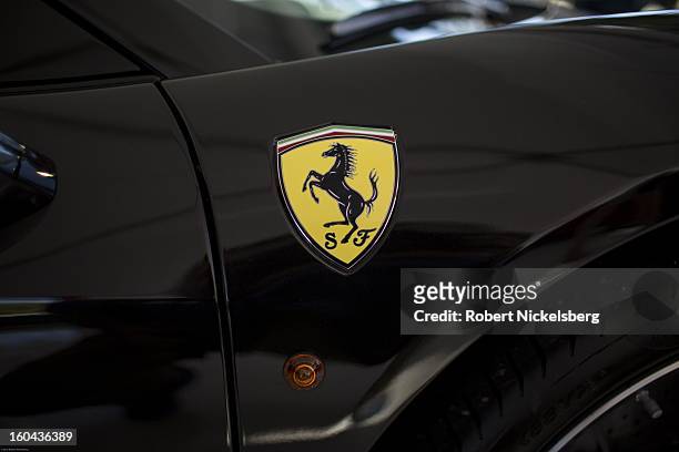 The famous Ferrari black stallion logo sits on the front panel of a new Ferrari automobile for sale at the annual Cavallino Auto Competition, January...
