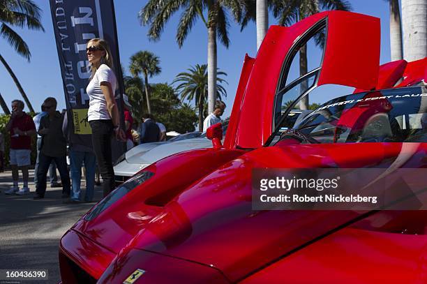 Sales woman stands next to a new Ferrari Enzo automobile for sale at the annual Cavallino Auto Competition, January 26, 2013 held at The Breakers...