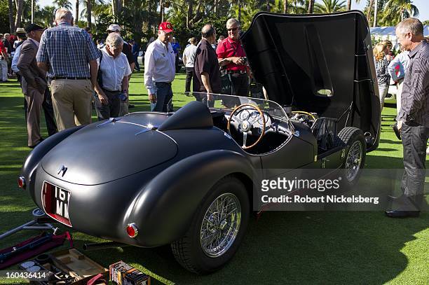 Spectators discuss the condition of a 1953 166 MM antique Ferrari automobile at the annual Cavallino Auto Competition, January 26, 2013 held at The...