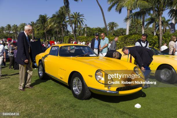 Judges discuss the quality of an antique Ferrari 275 GTB/4 automobile at the annual Cavallino Auto Competition, January 26, 2013 held at The Breakers...