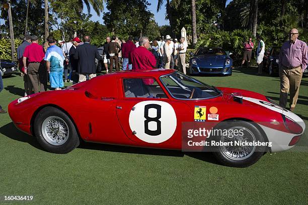 Judges and spectators inspect a 1964 250 LM antique Ferrari automobile at the annual Cavallino Auto Competition, January 26, 2013 held at The...