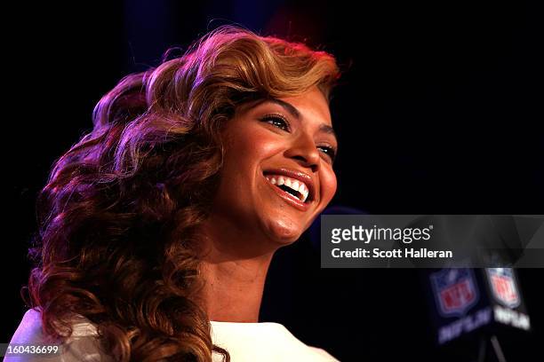 Singer Beyonce sings the national anthem before she addresses the media during the Pepsi Super Bowl XLVII Halftime Show press conference at the media...