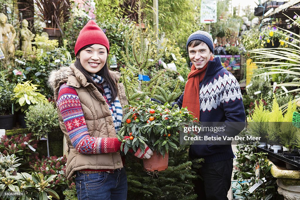 Couple choosing plants in gardencentre.