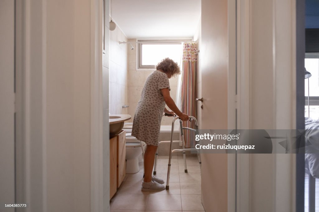 Elderly woman with a disability in the bathroom