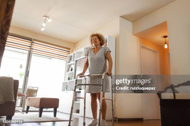 elderly woman with a disability and a walker exercising - hip surgery stock pictures, royalty-free photos & images