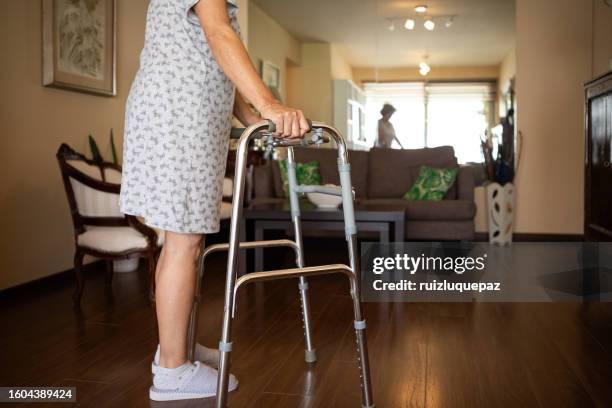 elderly woman with a disability and a walker exercising - hip replacement stock pictures, royalty-free photos & images