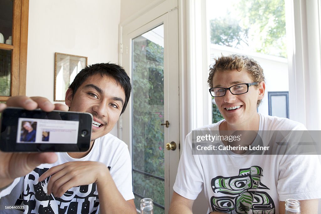 Two young men looking at iphone