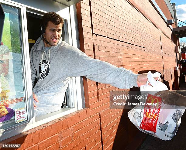 Brooklyn Nets player Kris Humphries participates in the "Random Acts of Kindness" program by serving McDonald's customers in the Prospect Lefferts...