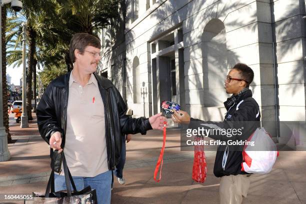 The NFL Extra Points Credit Card team distributes masks on the street for a chance to win tickets to Super Bowl XLVII on January 31, 2013 in New...