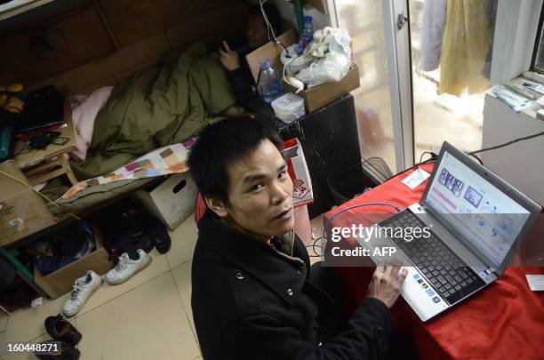 China-marriage-lifestyle-social,FEATURE" by Carol Huang This picture taken on January 31, 2013 shows Meng Guangyong using his laptop to operate a...