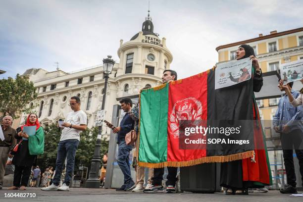 Group of demonstrators hold an Afghanistan flag during the demonstration in Madrid against the abuses of the Taliban regime. A demonstration against...