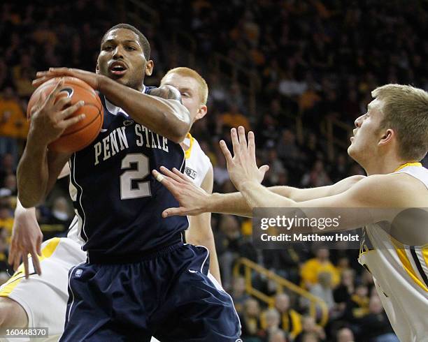 Guard D.J. Newbill of the Penn State Nittany Lions grabs a rebound during the first half in front of guard Josh Oglesby and forward Aaron White of...