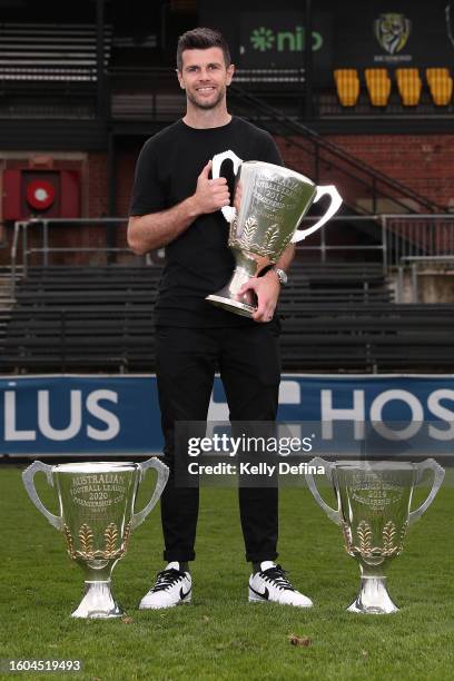 Trent Cotchin poses for a portrait with the 2017, 2019 and 2020 Premiership Cups after announcing his retirement from AFL during a press conference...