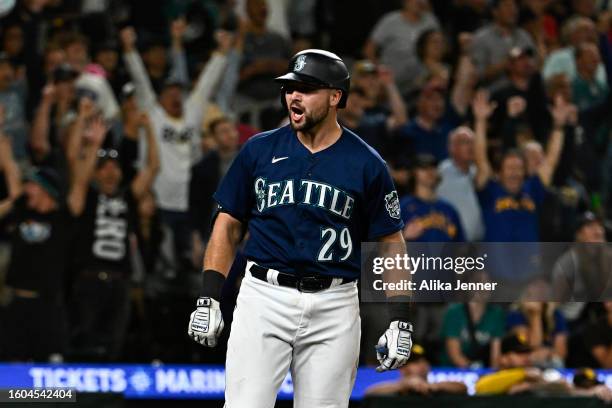 Cal Raleigh of the Seattle Mariners reacts after hitting a two-run home run during the eighth inning against the San Diego Padres at T-Mobile Park on...