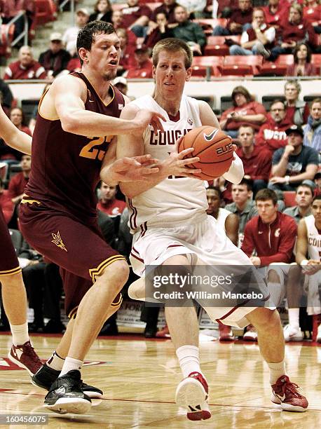 Forward Brock Motum of the Washington State Cougars plays against center Ruslan Pateev of the Arizona State Sun Devils during the second half of the...