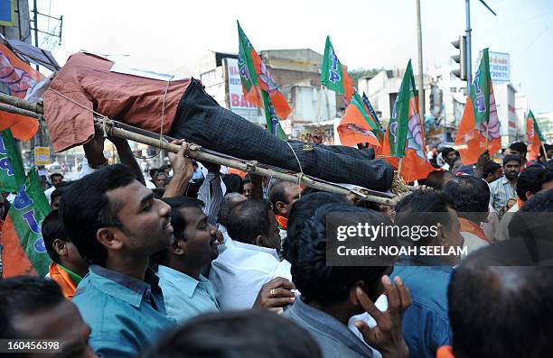 Members of the opposition Bharatiya Janata Party carry an effigy representing Central Home Minister Susheel Kumar Shinde during their protest...