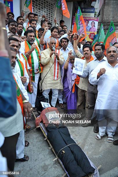 Members of the opposition Bharatiya Janata Party surround an effigy representing Central Home Minister Susheel Kumar Shinde during their protest...