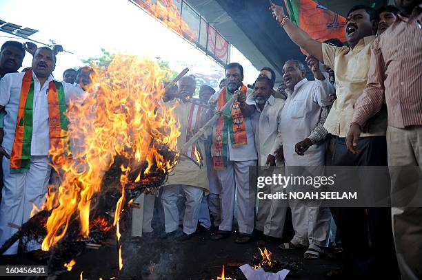 Members of the opposition Bharatiya Janata Party burn an effigy representing Central Home Minister Susheel Kumar Shinde during their protest...
