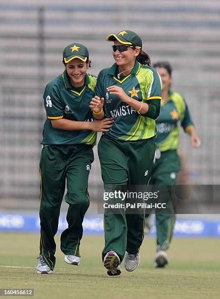 Pakistan captain Sana Mir celebrates a wicket with teammate Javeria Khan during the second match of ICC Womens World Cup between Australia and...
