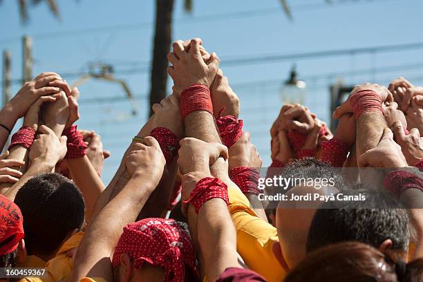 castellers making 'pinya' - castell stock pictures, royalty-free photos & images