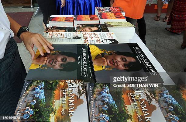 Visitors browse books on sale at a stand outside a hotel hosting Myanmar's first international literary festival, in Yangon on February 1, 2013. The...