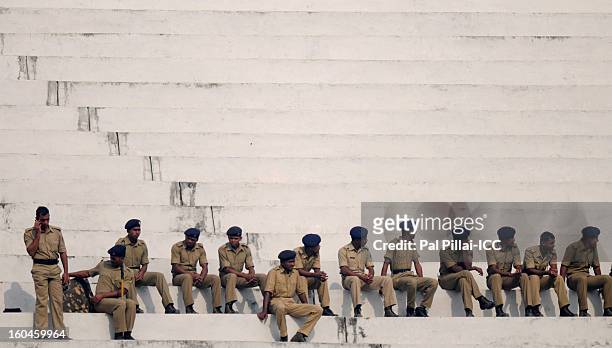 Police officers watch the second match of ICC Womens World Cup between Australia and Pakistan, played at the Barabati stadium on February 1, 2013 in...