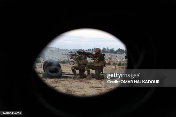 Fighters from the jihadist group Hayat Tahrir al-Sham , headed by ex-members of Syria's former Al-Qaeda franchise, demonstrate their battle skills...