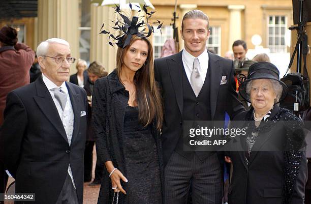 England football captain David Beckham stands with his wife, Victoria, and his maternal grandparents, Joseph and Peggy West, as he shows off the OBE...