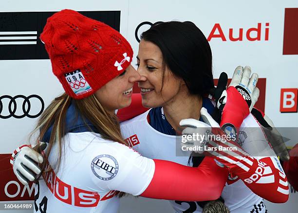 Shelley Rudman of Great Britain celebrates with second placed Noelle Pikus Pace of USA after winning the women's skeleton final heat of the IBSF Bob...