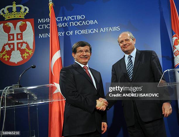 Turkey's Foreign Minister Ahmet Davutoglu shakes hand with his Serbian counterpart Ivan Mrkic at a press conference following their meeting in...